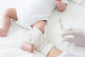 Nurse administering Vitamin K to newborn before Circumcision